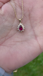 Load and play video in Gallery viewer, Necklace - Ruby Pendant in 12 Diamond Halo Setting
