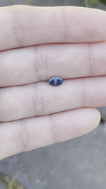 Load and play video in Gallery viewer, Montana Sapphire .98 CT Dark Blue, Silver with Hints of Gold Oval Cut
