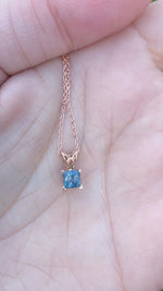 Load and play video in Gallery viewer, Pendant - Montana Sapphire .60 CT Blue Princess Cut set in 14k Rose Gold Scroll
