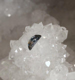 Load image into Gallery viewer, Montana Sapphire .53 CT Silver, Lavender, Peach, Light Blue and Green with RARE Garnet Inclusion Half Moon Cut - Collectable
