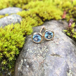Load image into Gallery viewer, Earrings - Montana Sapphire .58 CTW Light Blue Round in 14K Yellow Gold Bezel Set Studs
